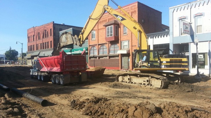 Brick Paver's Construction operating a Cat Excavator in downtown Hillsdale