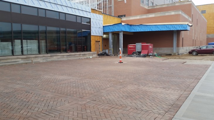 A brick sidewalk made by Brick Paver Construction placed in front of downtown buildings