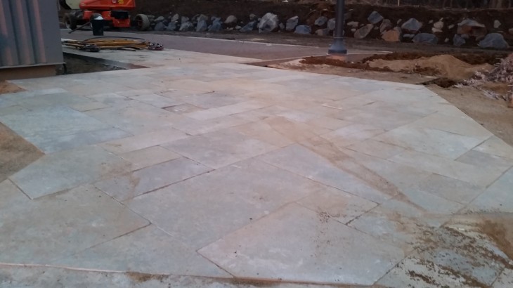 A stone pathway built in an excavation site by Brick Pavers Construction