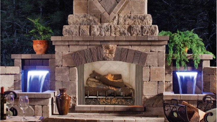 A stylized outdoor fireplace made out of bricks and stone