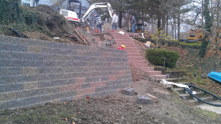 Brick Pavers Construction workers building a brick retaining wall and brick steps