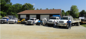 Brick Paver Construction team standing next to their trucks and construction equipment